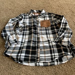 Black white and tan plaid shirt. Tan suede pocket detail.